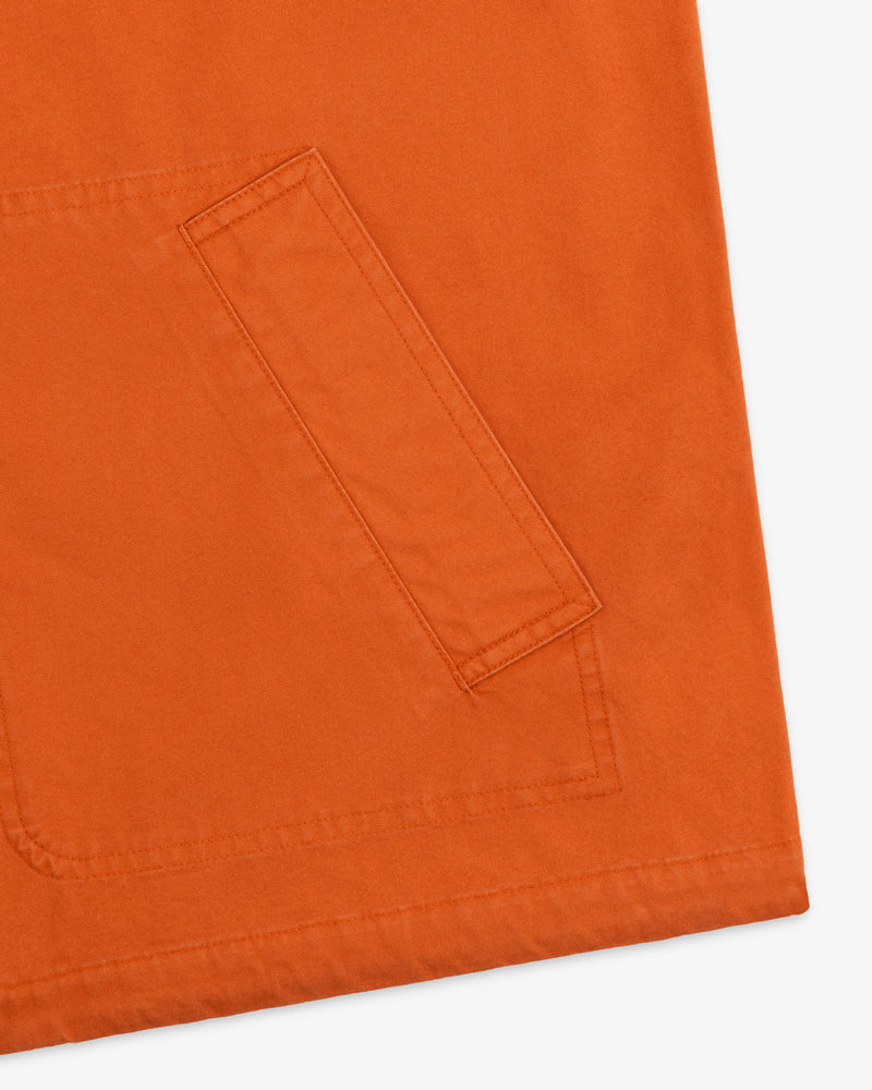 Close-up of a burnt orange Garment Washed Anorak featuring a large rectangular front pocket.