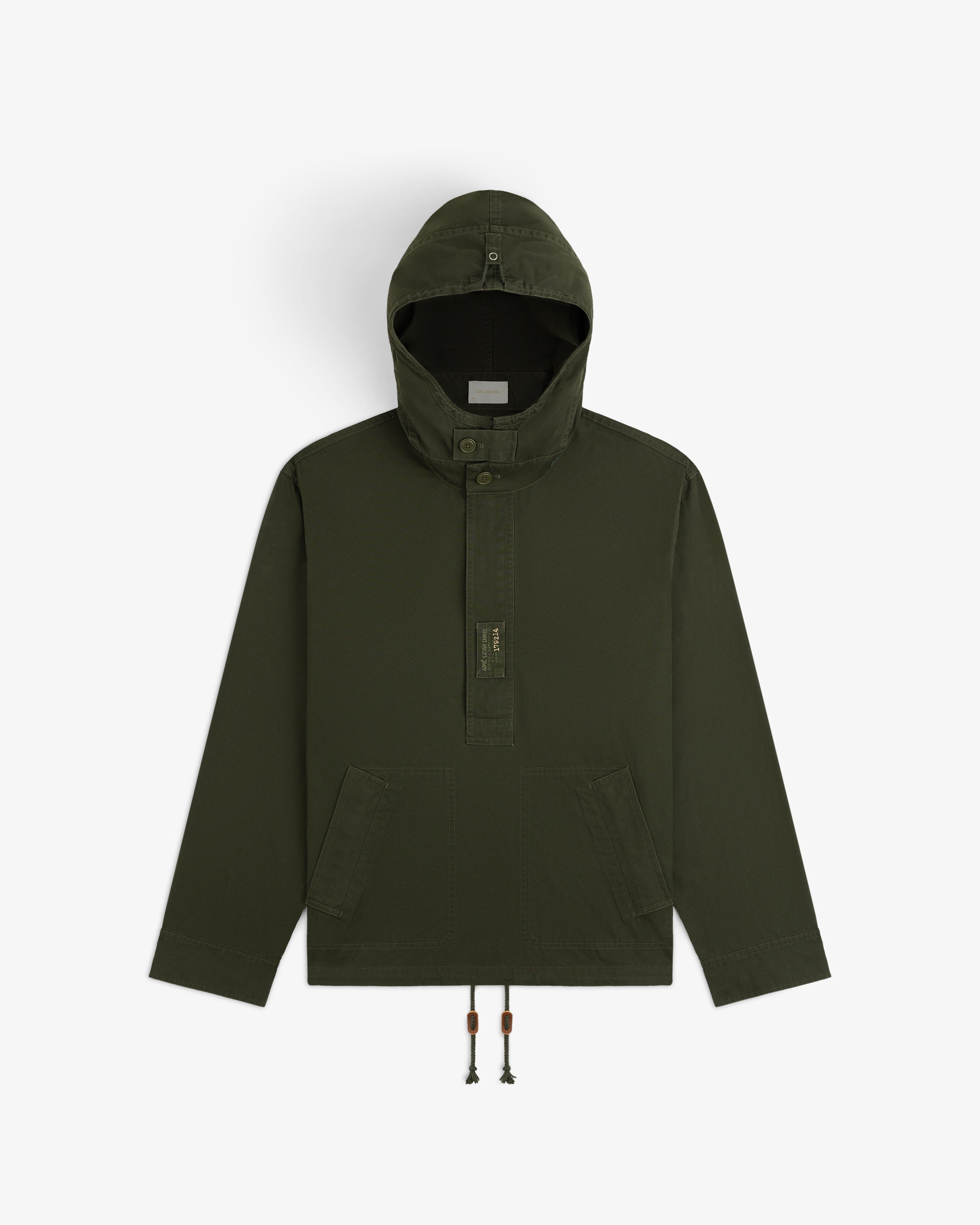 Garment Washed Anorak in olive green, featuring a hooded pullover design, buttoned placket, and drawstring hem.