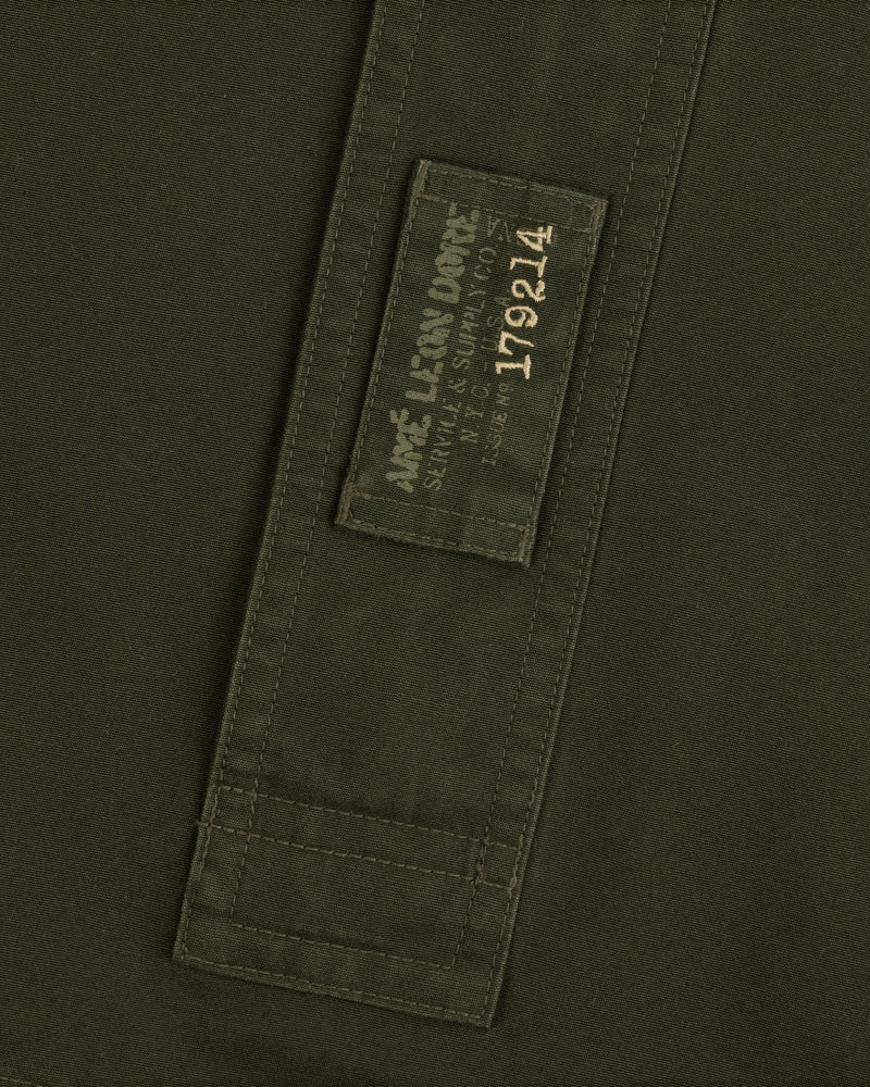 Olive green Garment Washed Anorak fabric with a rectangular patch featuring branded text and the number 179214.