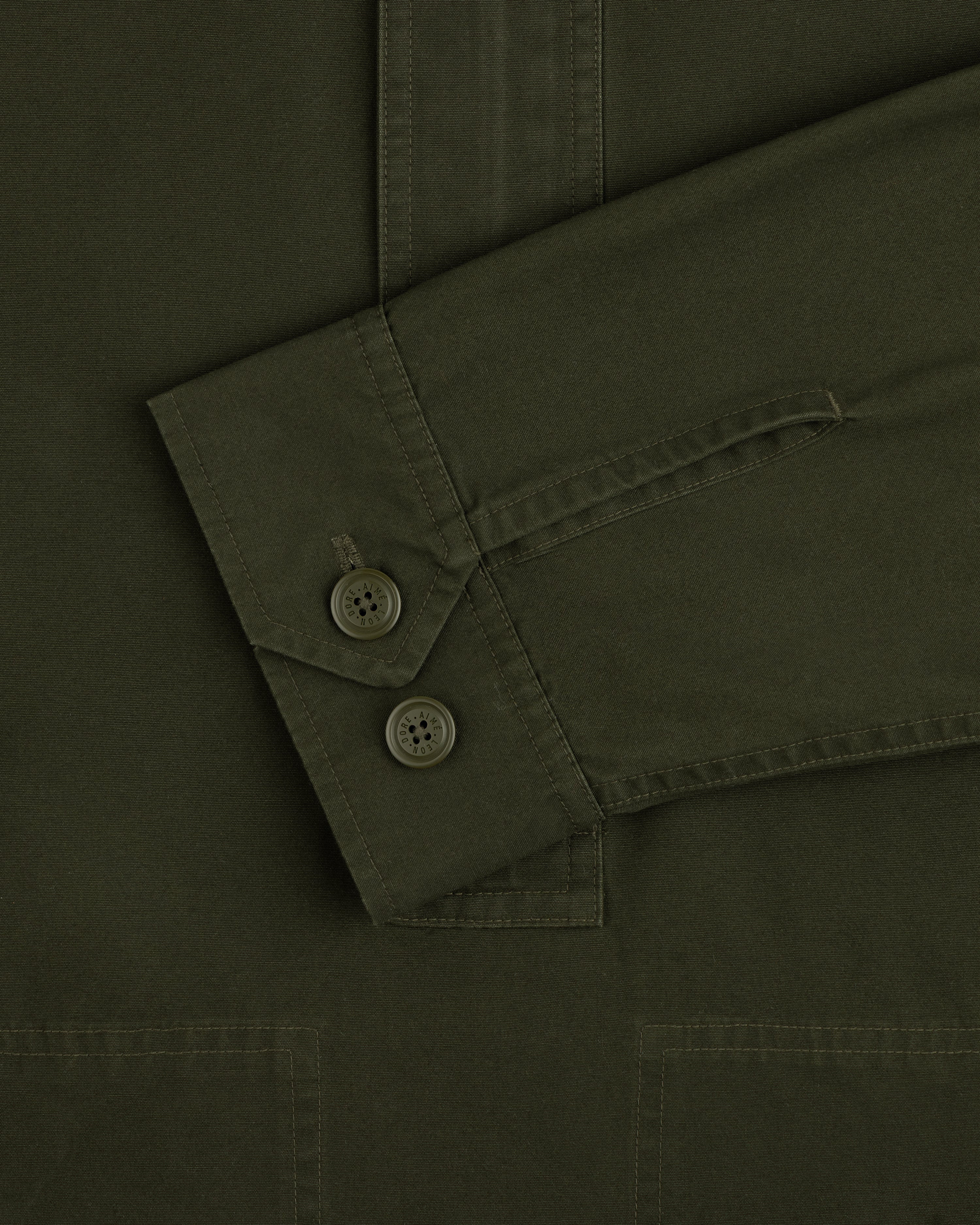 Olive green Garment Washed Anorak sleeve with a two-button cuff.