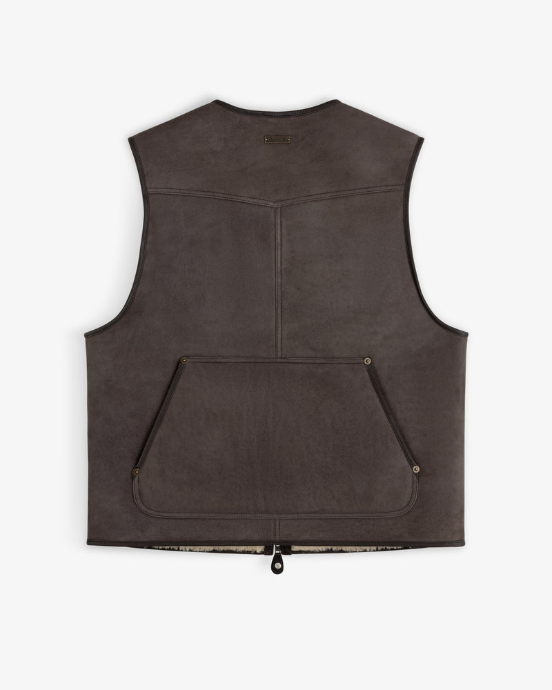Back view of a dark brown Shearling Biker Vest with a large pocket and exposed shearling lining at the hem.