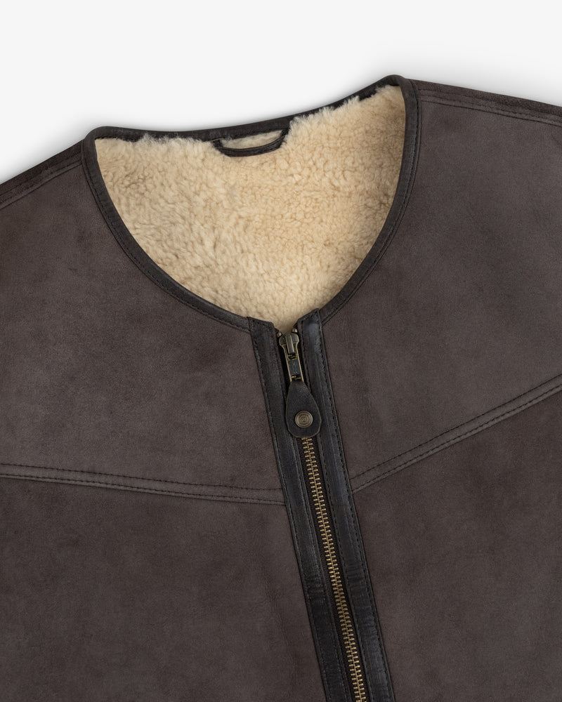 Shearling Biker Vest in dark brown suede with a cream-colored shearling lining and a center front zipper.