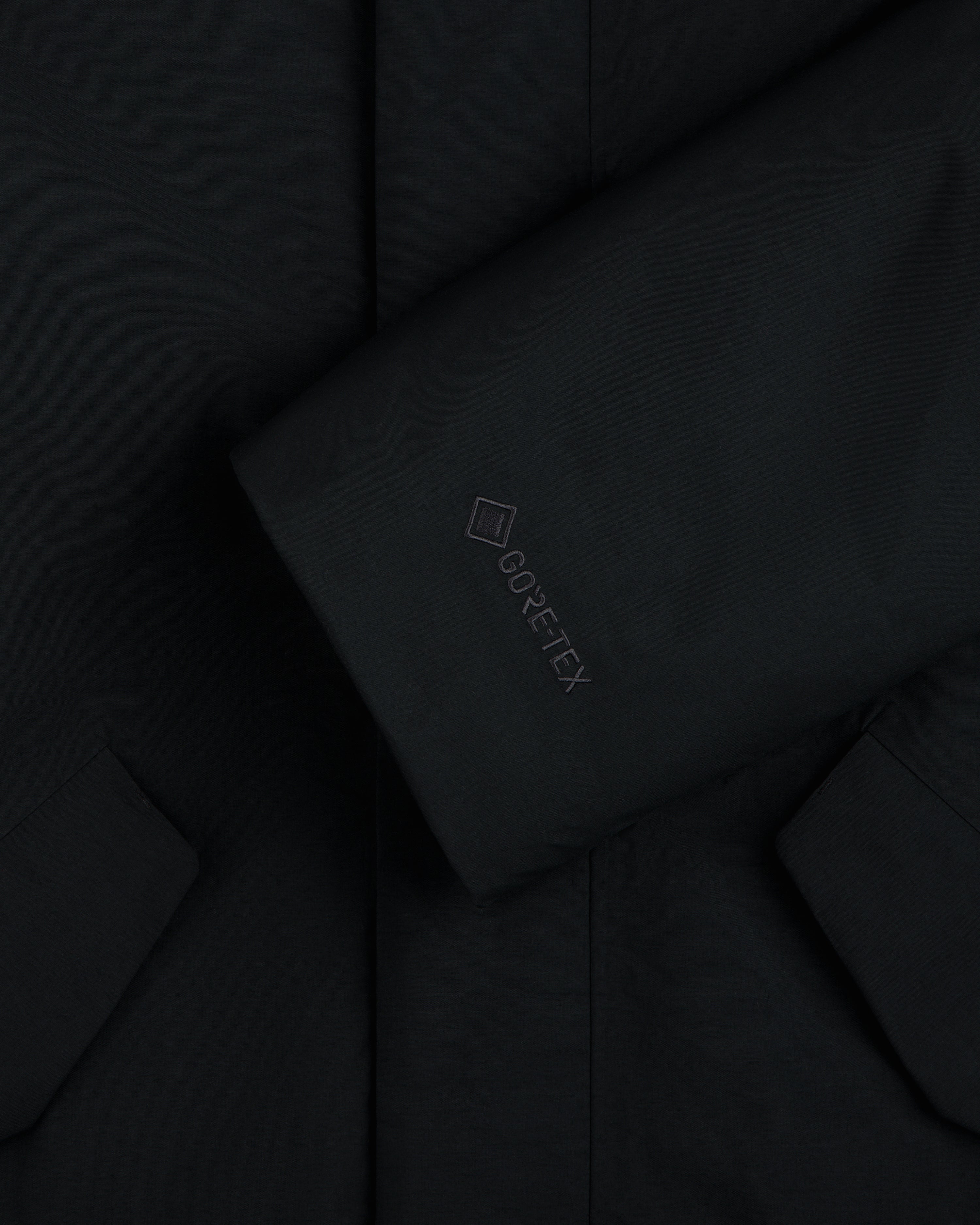 Close-up of a black GORE-TEX Down Filled Fishtail Parka sleeve with a tonal GORE-TEX logo.