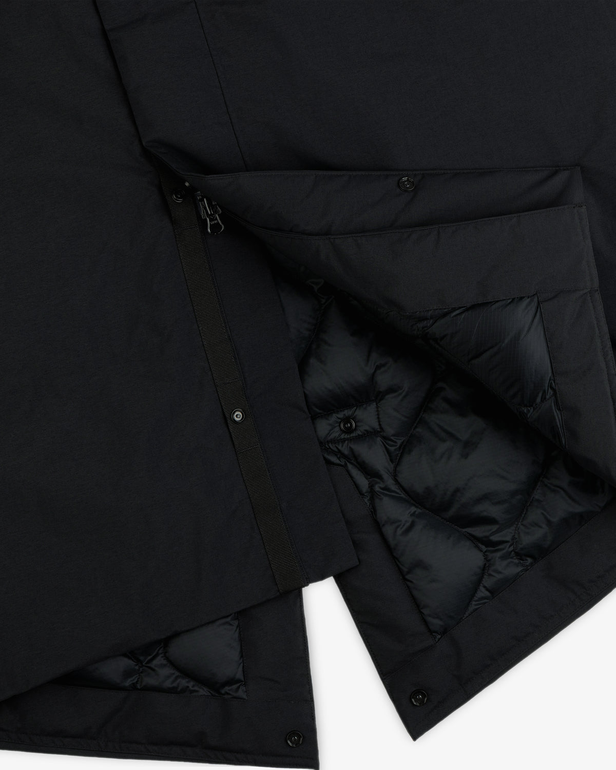 Black GORE-TEX Down Filled Fishtail Parka with a zipper, snap buttons, and a quilted interior lining.