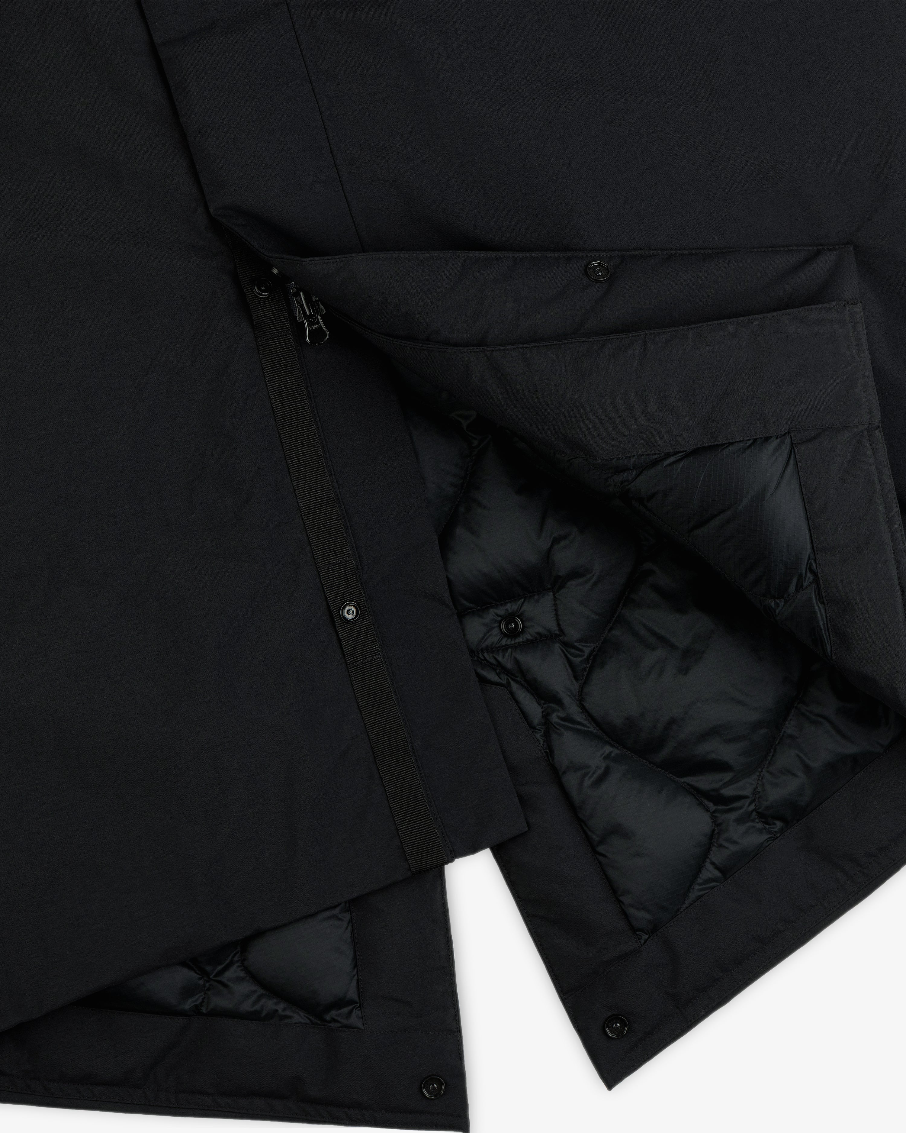 Black GORE-TEX Down Filled Fishtail Parka with a zipper, snap buttons, and a quilted interior lining.