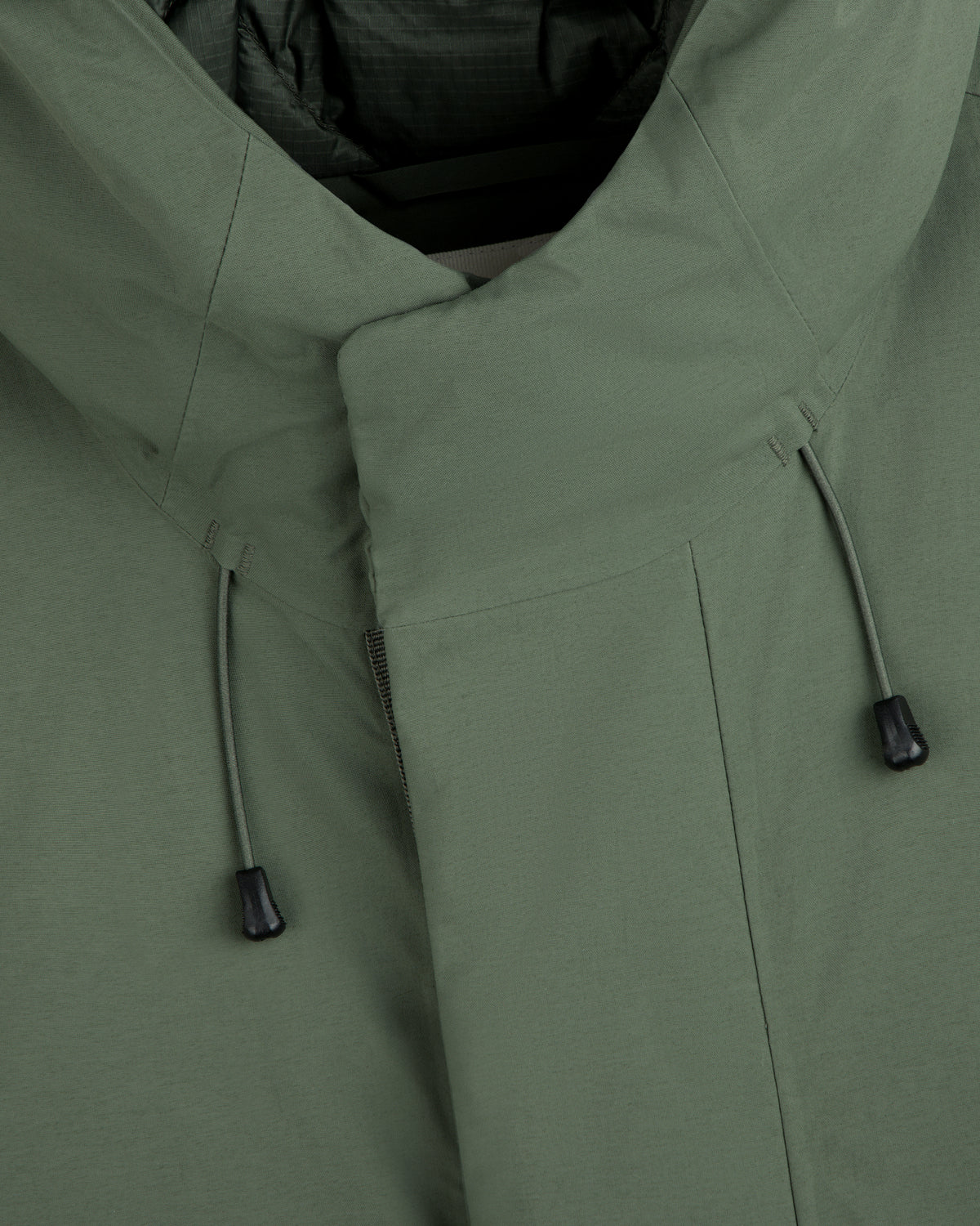 Close-up of an olive green GORE-TEX Down Filled Fishtail Parka with a high collar and drawstring cords.