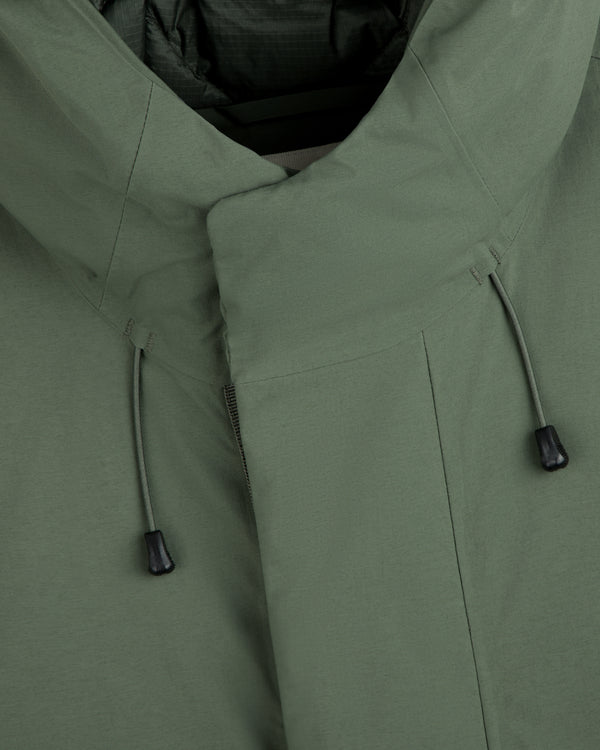 Close-up of an olive green GORE-TEX Down Filled Fishtail Parka with a high collar and drawstring cords.