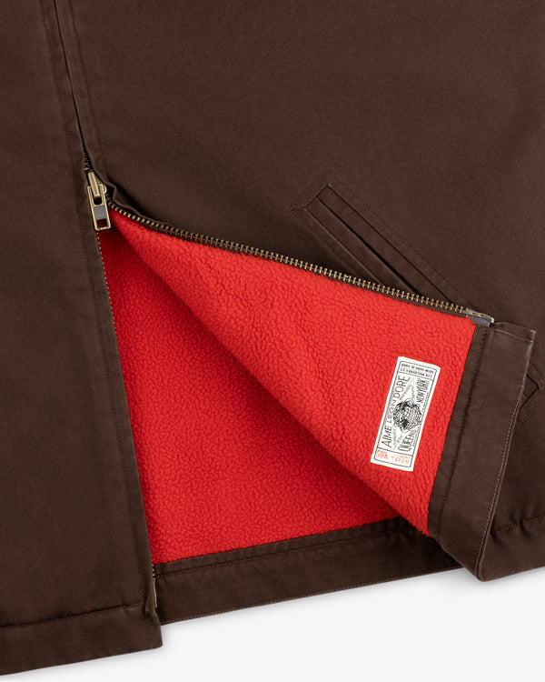 Fleece Lined Mechanic Jacket in brown, partially unzipped to reveal a bright red lining and brand tag.