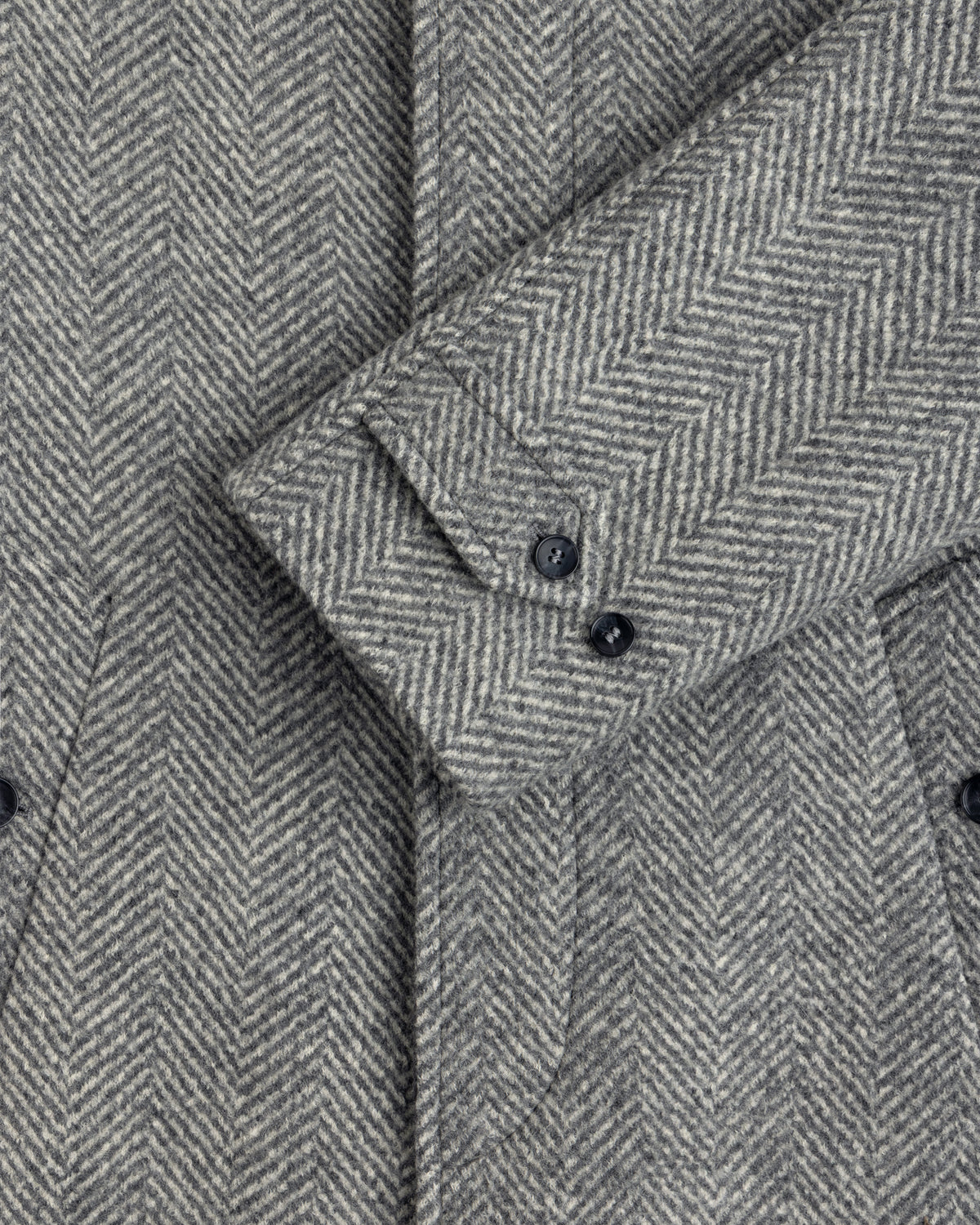 Grey Wool Herringbone Overcoat sleeve featuring two buttons on the cuff.