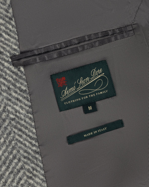 Interior of a Wool Herringbone Overcoat showing a dark green brand label, a size M tag, and a Made in Italy label.