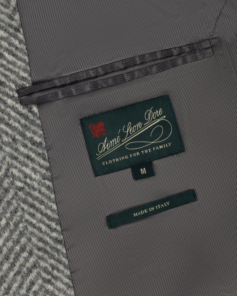 Interior of a Wool Herringbone Overcoat showing a dark green brand label, a size M tag, and a Made in Italy label.