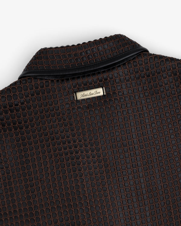Close-up of a brown and black Woven Leather Jacket collar with a metal brand tag at the neckline.