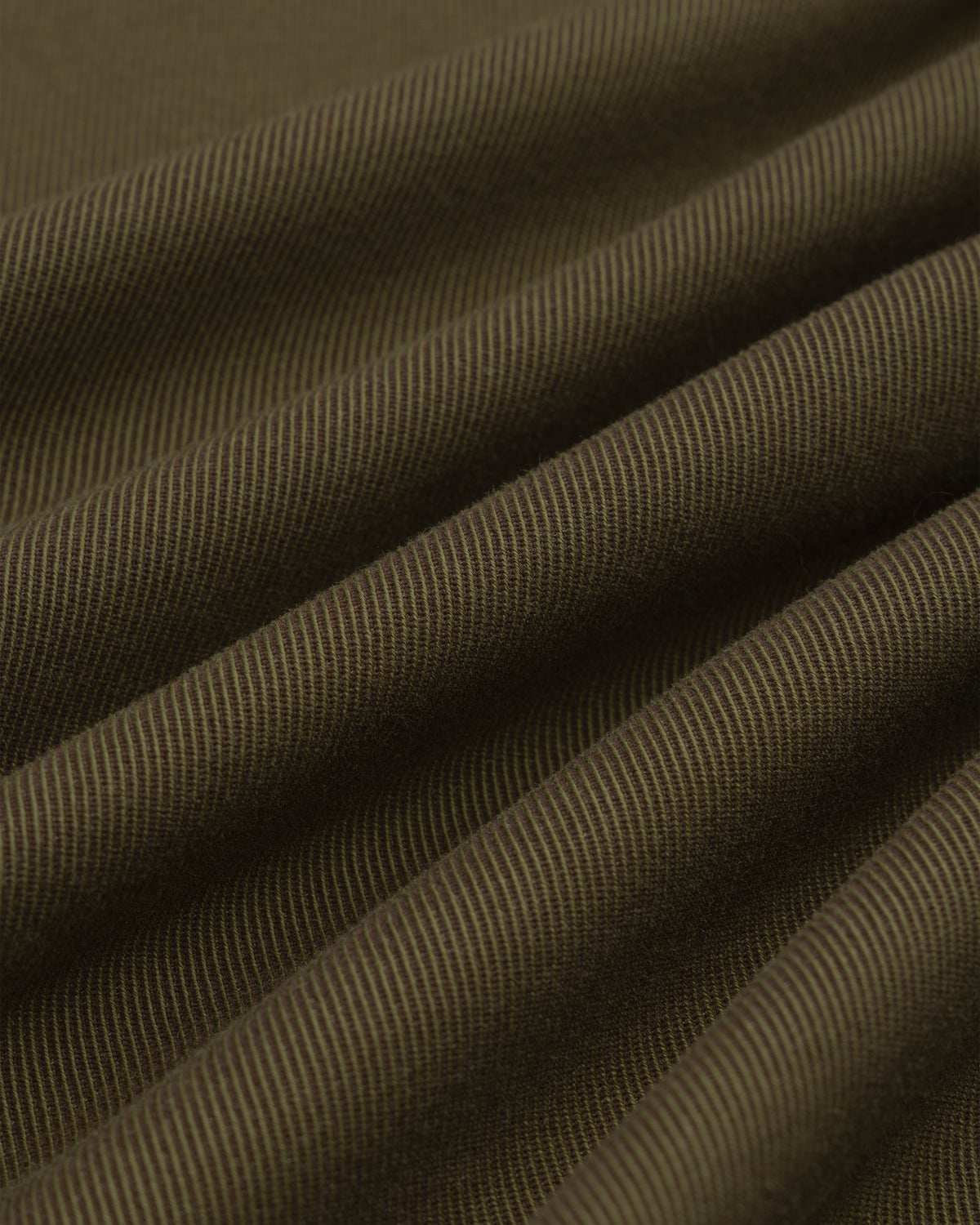 Close-up of olive green Single-Breasted Wool Blend Suit Jacket fabric with diagonal ridges in soft, flowing drapes.