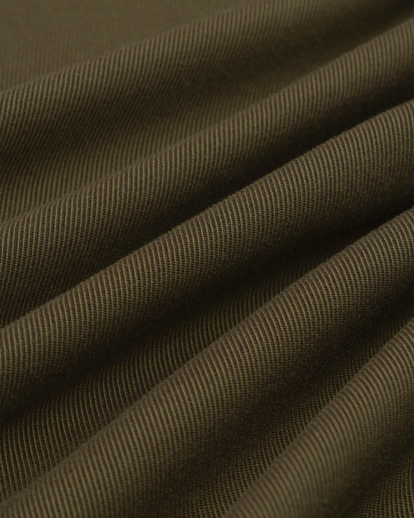 Close-up of olive green Single-Breasted Wool Blend Suit Jacket fabric with diagonal ridges in soft, flowing drapes.