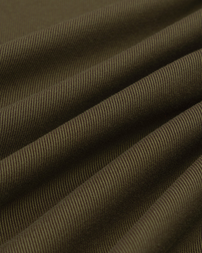 Close-up of olive green Single-Breasted Wool Blend Suit Jacket fabric with diagonal ridges in soft, flowing drapes.