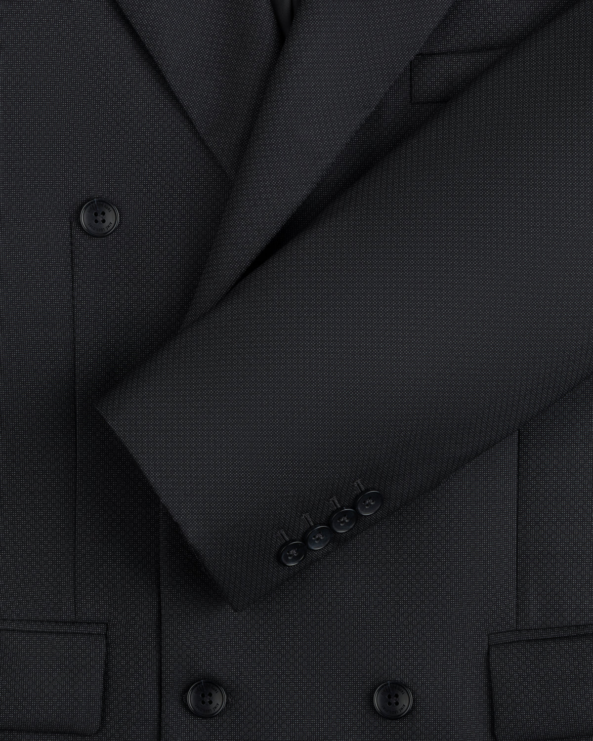 Close-up of a charcoal gray Double-Breasted Wool Jacquard Suit Jacket with button cuffs.