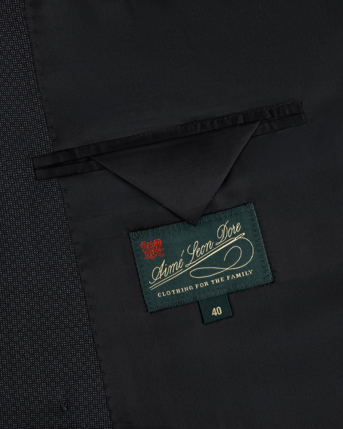 Interior of a Double-Breasted Wool Jacquard Suit Jacket showing a breast pocket and an Aimé Leon Dore label above size 40.
