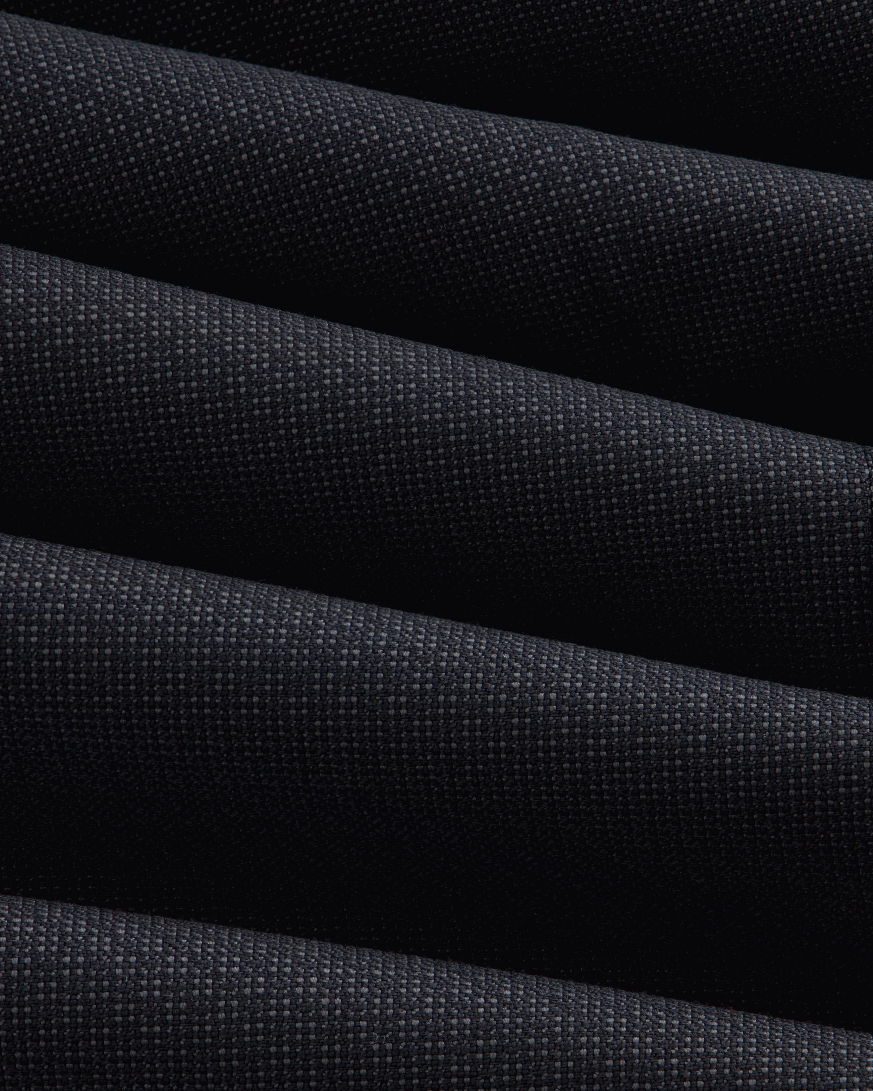 Close-up of the dark, textured fabric of a Double-Breasted Wool Jacquard Suit Jacket with prominent diagonal folds.