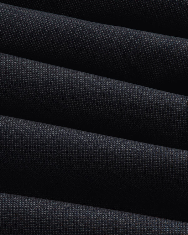 Close-up of the dark, textured fabric of a Double-Breasted Wool Jacquard Suit Jacket with prominent diagonal folds.