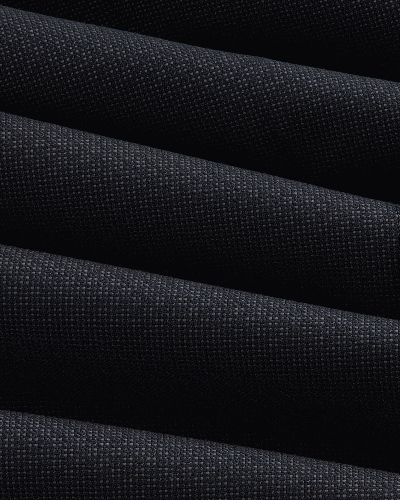 Close-up of the dark, textured fabric of a Double-Breasted Wool Jacquard Suit Jacket with prominent diagonal folds.