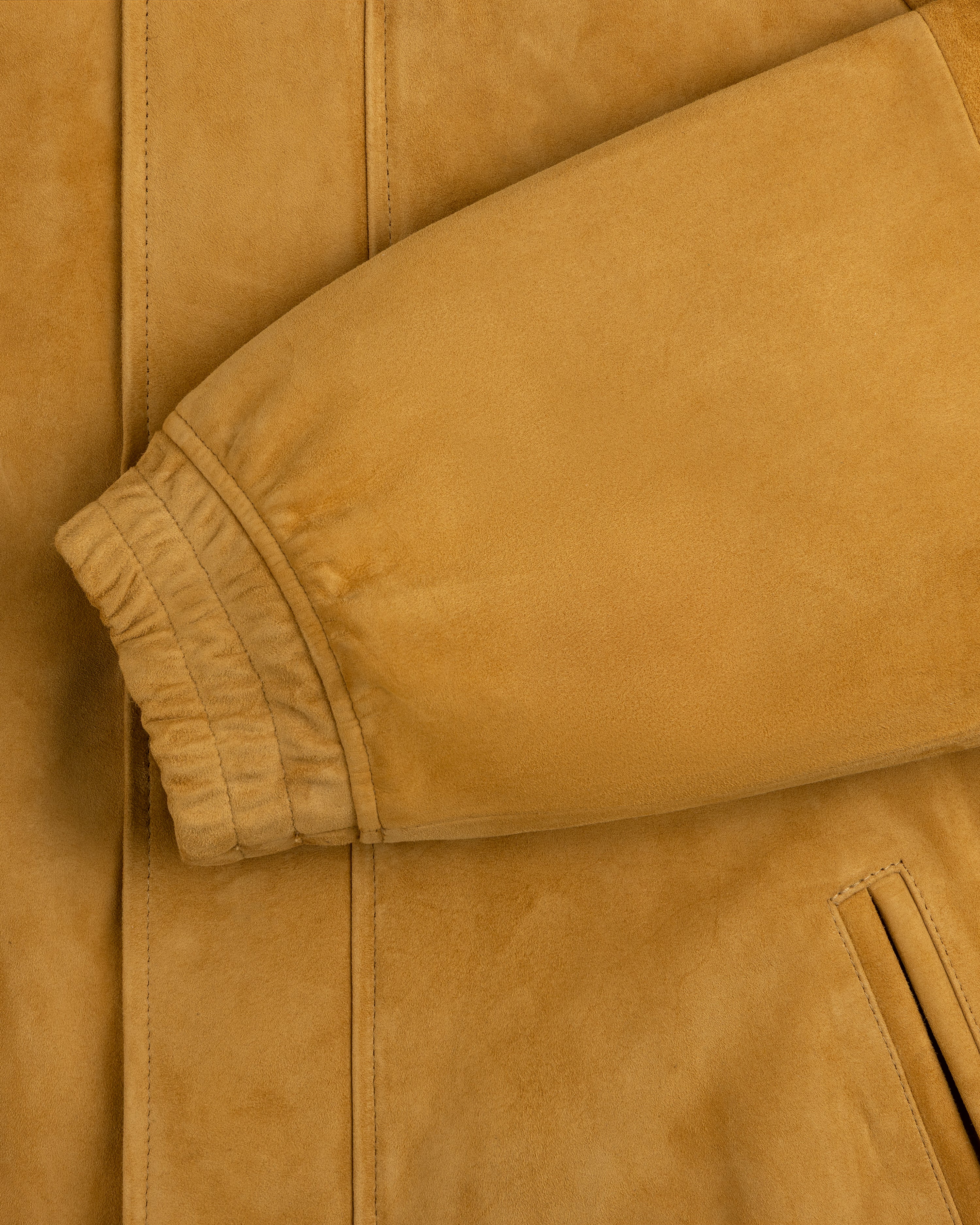 Close-up of Suede Cafe Racer Jacket’s tan sleeve with ribbed cuff and slanted pocket detail.