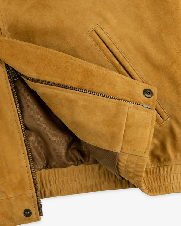 Close-up of the Suede Cafe Racer Jacket showing a zipper, brown lining, and a slanted front pocket.