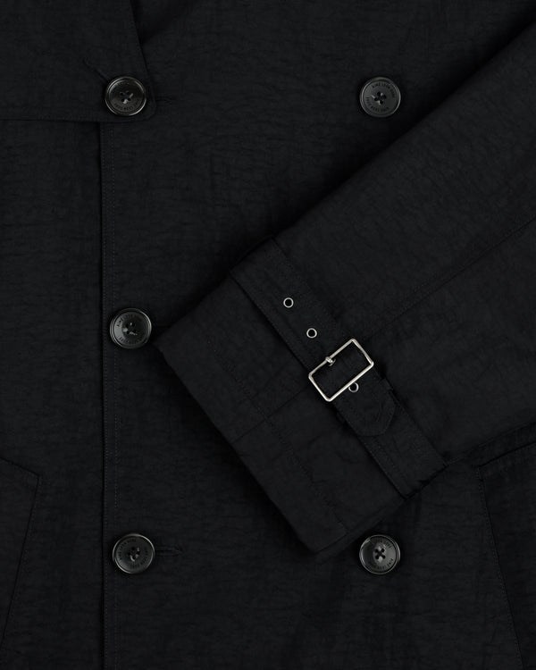 Close-up of the Double Breasted Nylon Trench Coat, featuring black buttons and a sleeve with a small silver buckle.