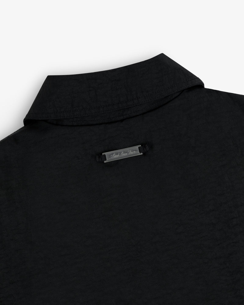 Close-up of the back collar of the Double Breasted Nylon Trench Coat with a small metallic nameplate below the collar.