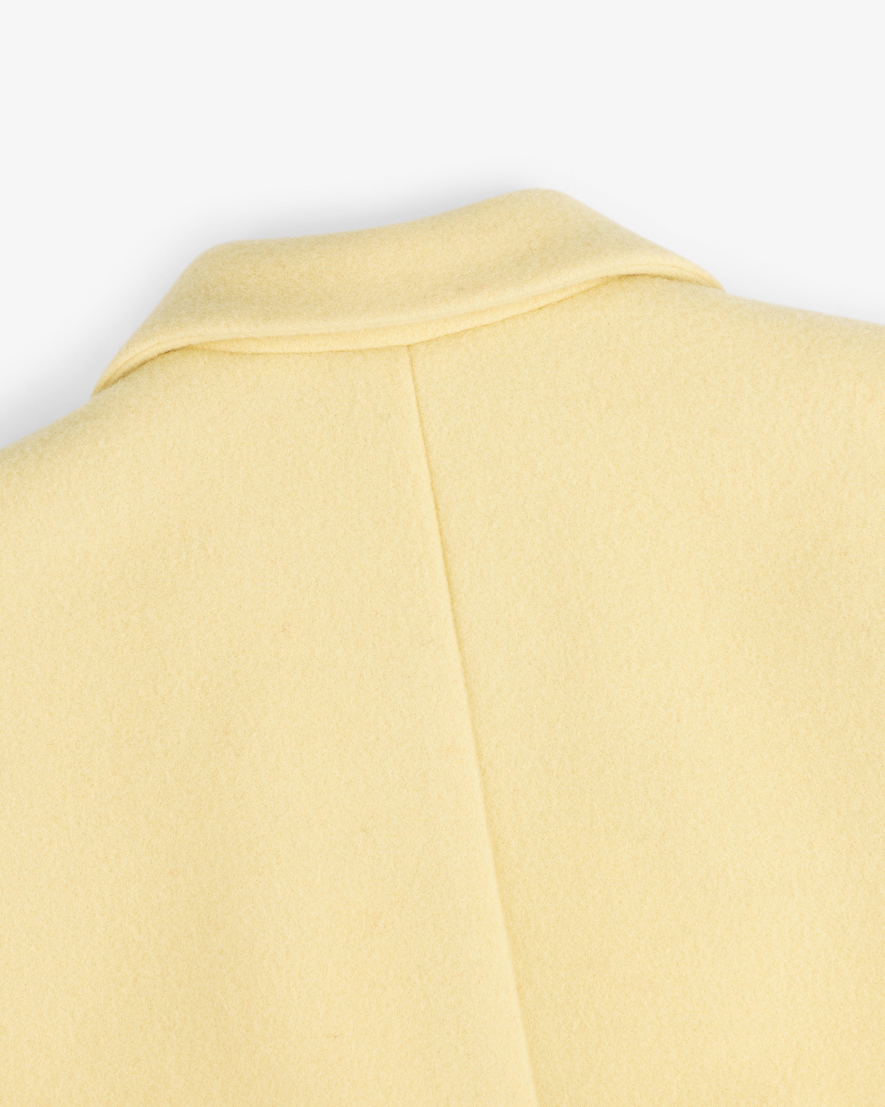 Close-up of the collar and back seam of a pale yellow Wool Sportcoat.