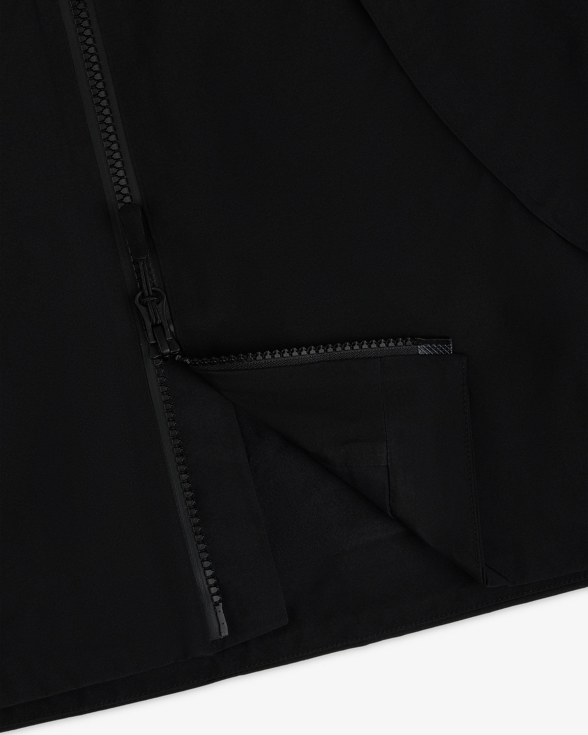 A close-up of a black Cropped GORE-TEX Shell Jacket featuring a heavy-duty front zipper.