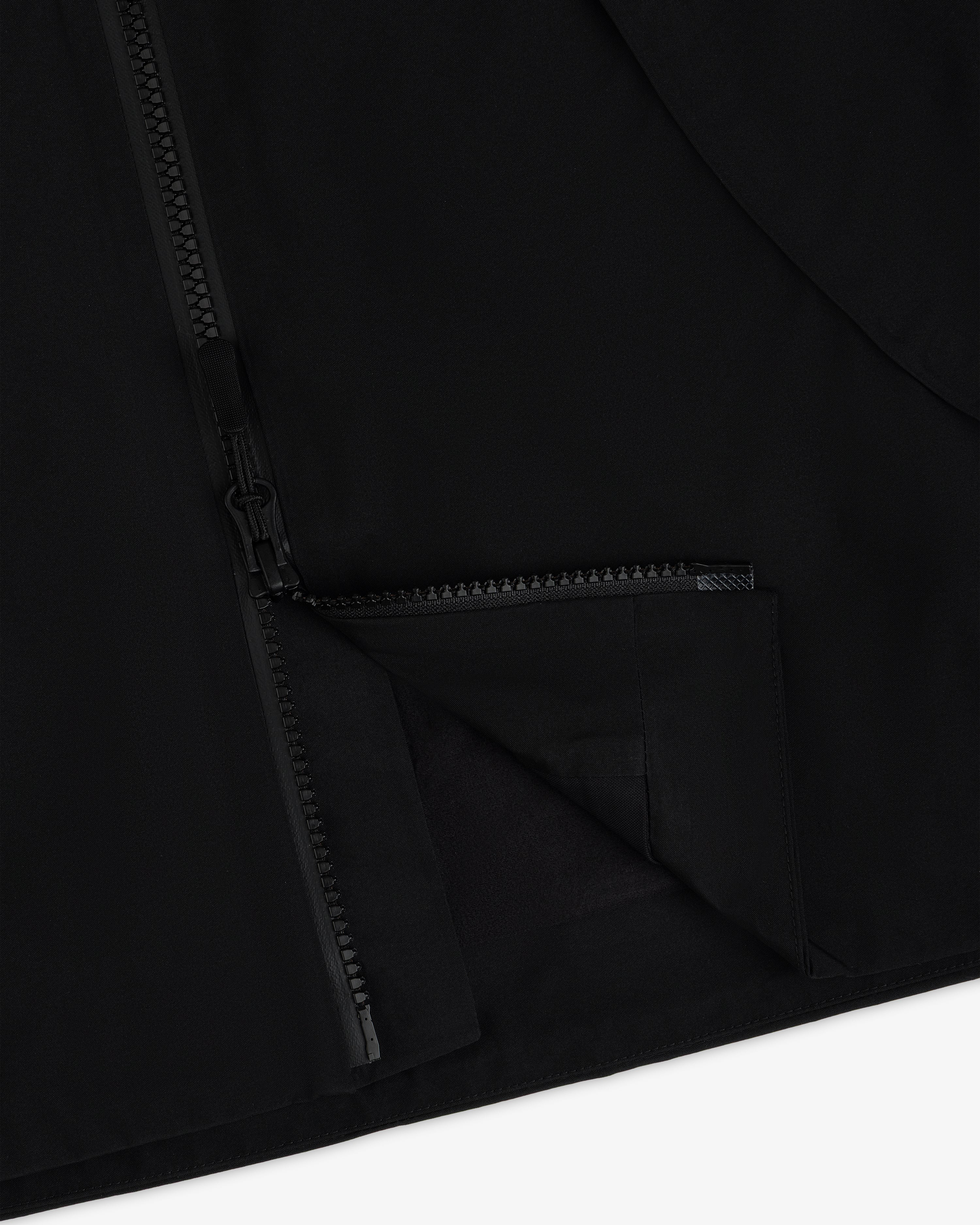 A close-up of a black Cropped GORE-TEX Shell Jacket featuring a heavy-duty front zipper.