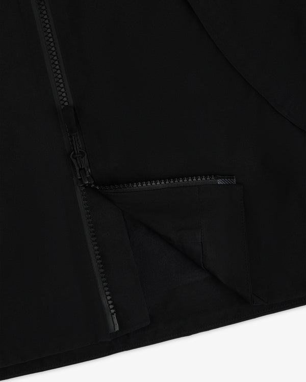 A close-up of a black Cropped GORE-TEX Shell Jacket featuring a heavy-duty front zipper.