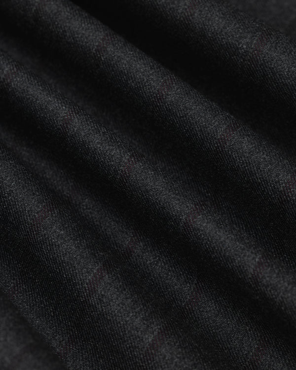 Close-up of a Collarless Striped Blazer in black fabric with faint, dark red pinstripes in soft folds.