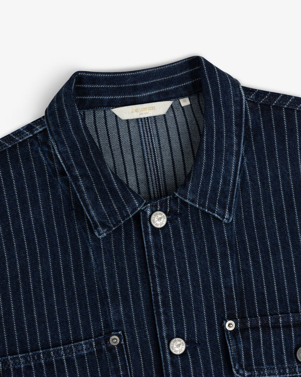 Chalk Stripe Denim Trucker Jacket in dark blue with white stripes, collar, silver buttons, and chest pockets shown close up.