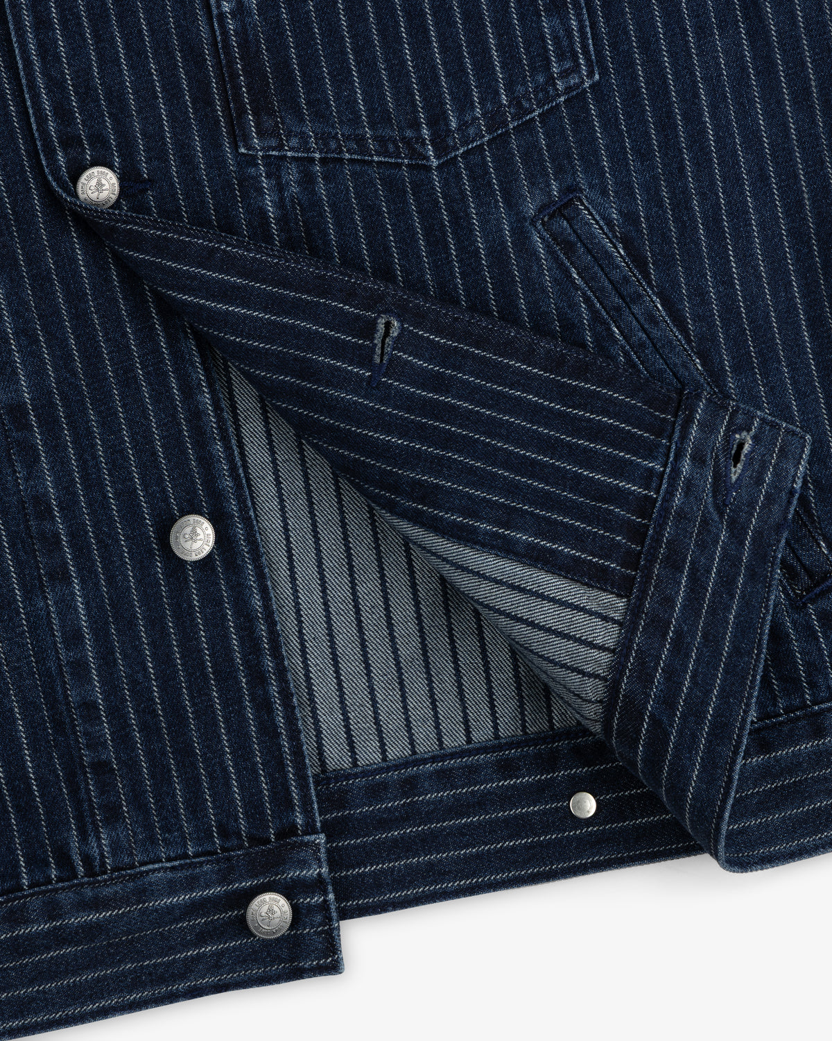 Chalk Stripe Denim Trucker Jacket in dark blue denim with silver buttons, shown partially unbuttoned.