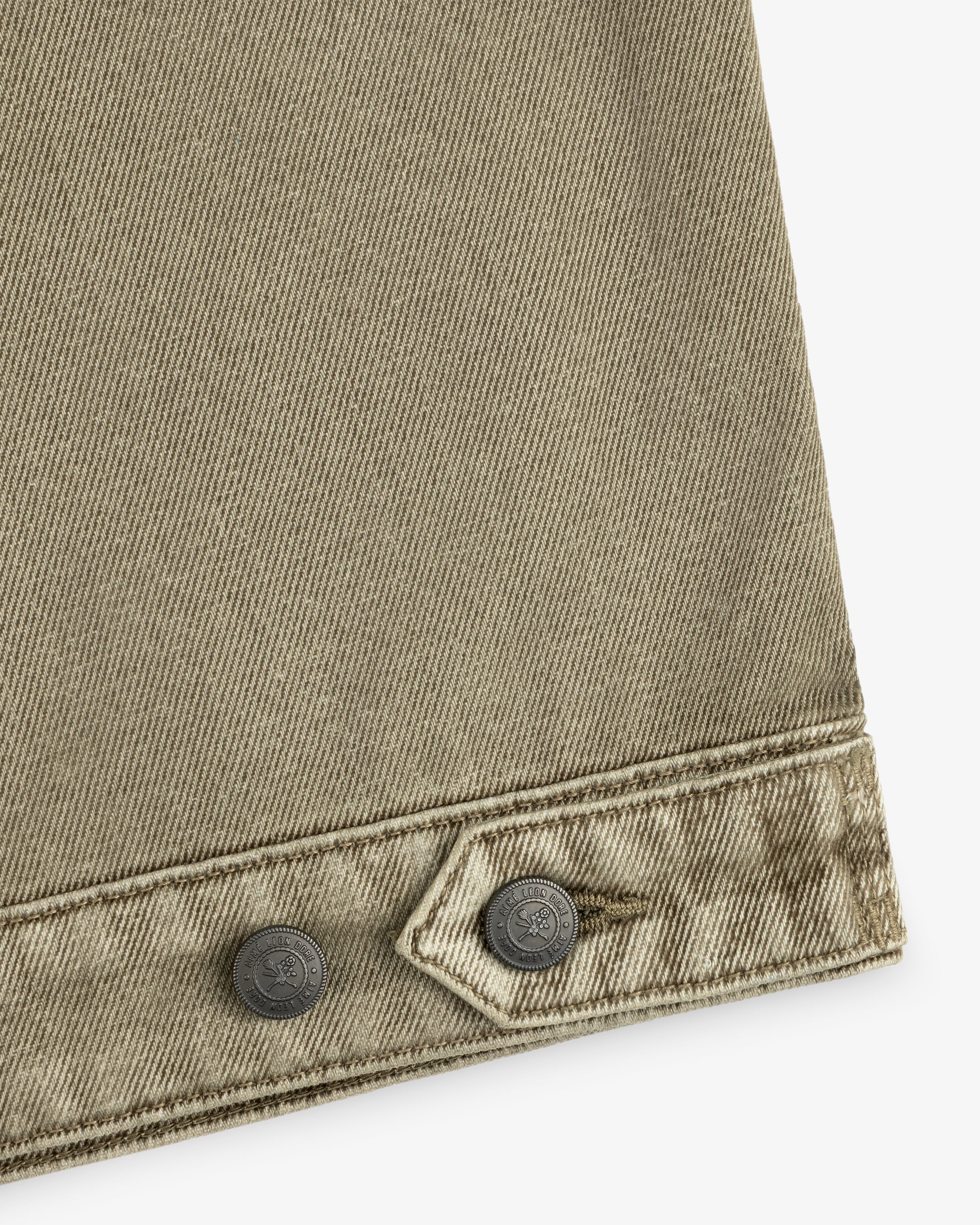 Olive green Flocked Denim Jacket detail showing a buttoned hem and two metallic buttons.