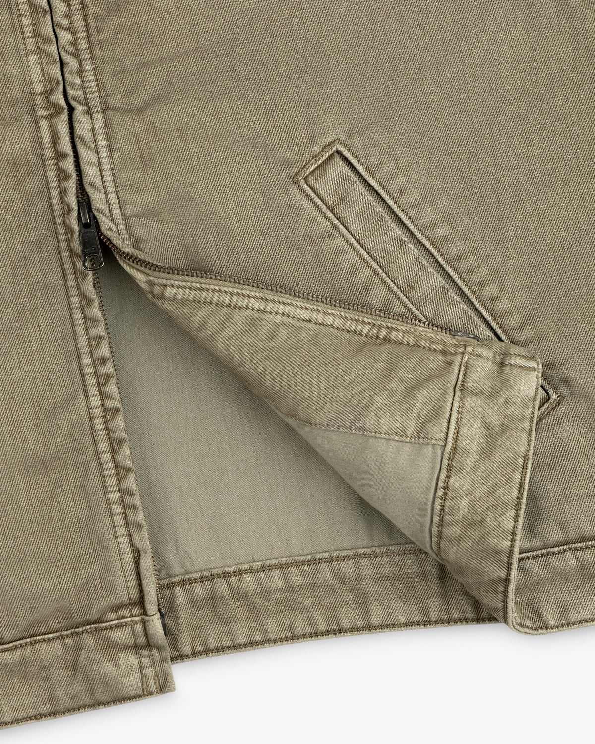 Close-up of an olive green Flocked Denim Jacket with a front zipper and a side pocket.