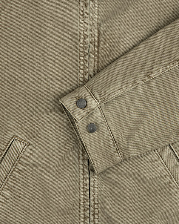 Olive green sleeve of a Flocked Denim Jacket featuring a buttoned cuff.