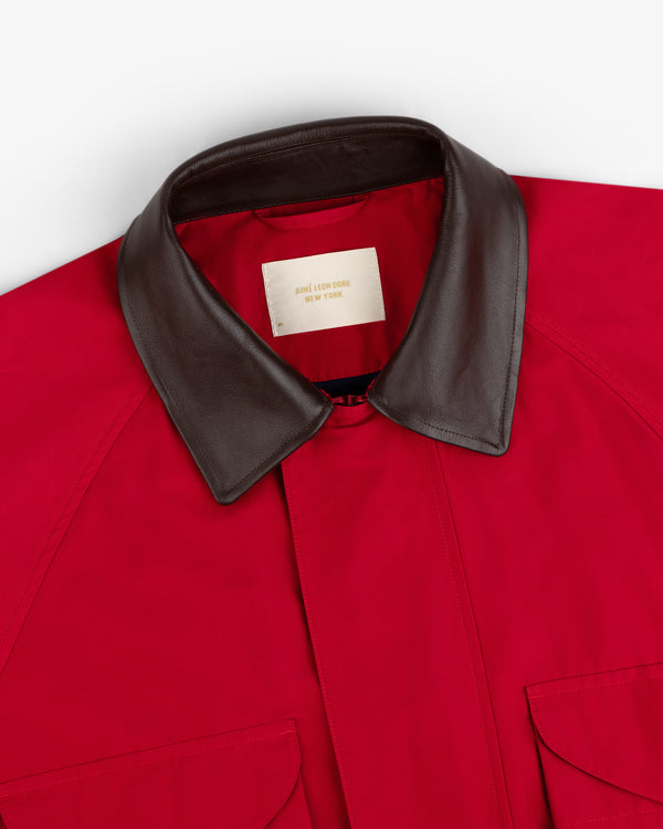 Lightweight Barn Jacket: red with brown leather collar, two pockets, and beige Aimé Leon Dore New York label.