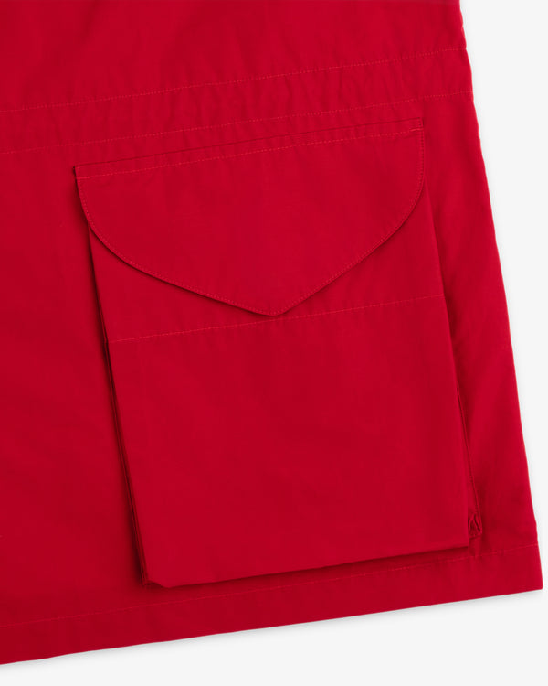 Close-up of the Lightweight Barn Jacket’s red fabric with a large stitched flap pocket.