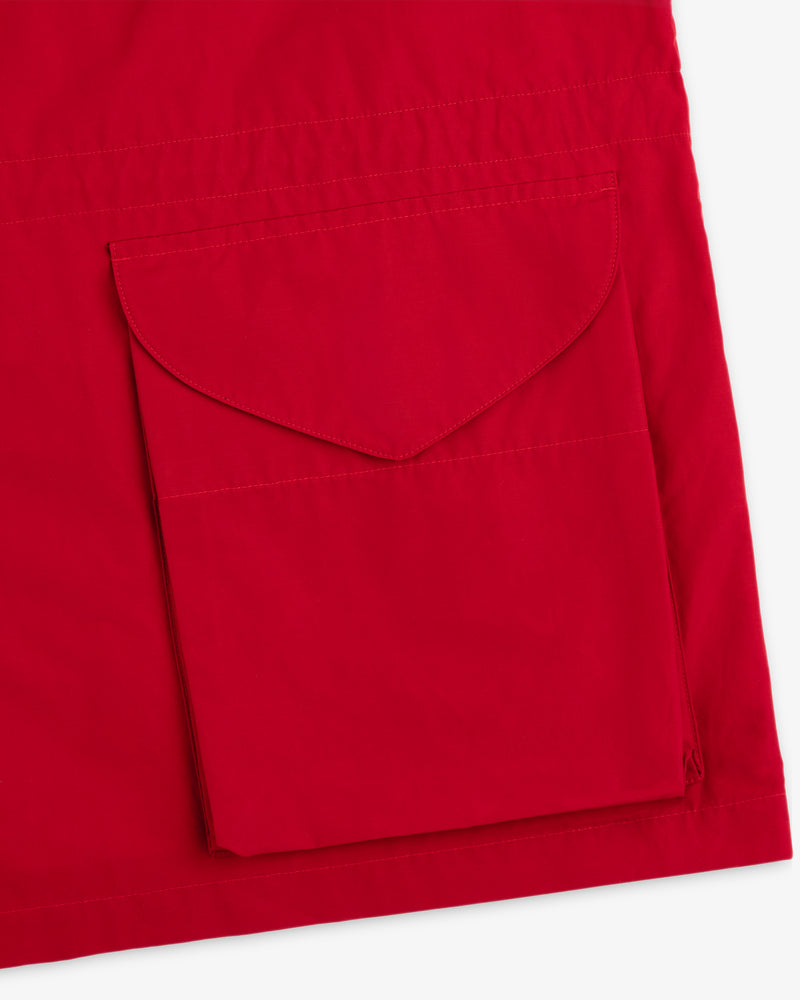 Close-up of the Lightweight Barn Jacket’s red fabric with a large stitched flap pocket.
