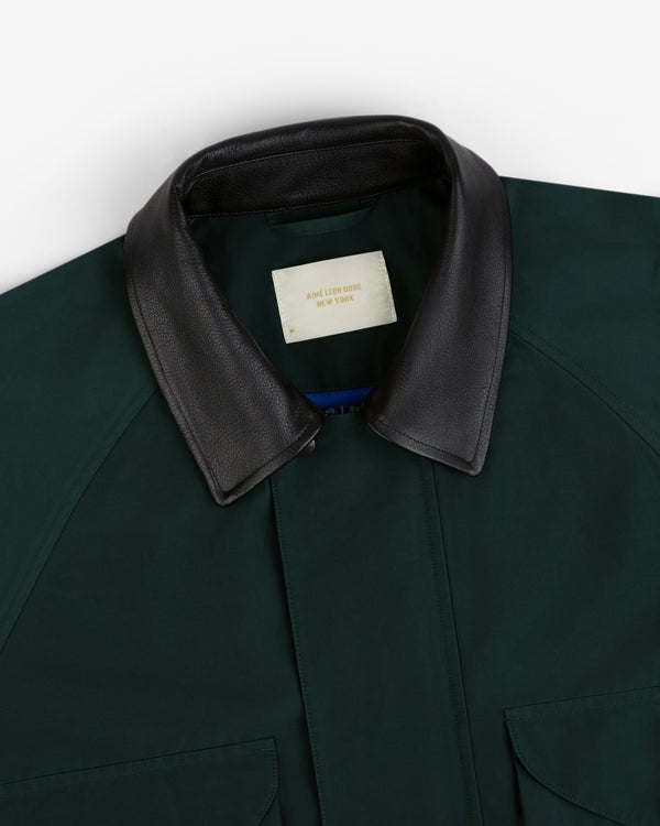 Dark green Lightweight Barn Jacket with black leather collar, partially open to show cream AIME LEON DORE NY label.
