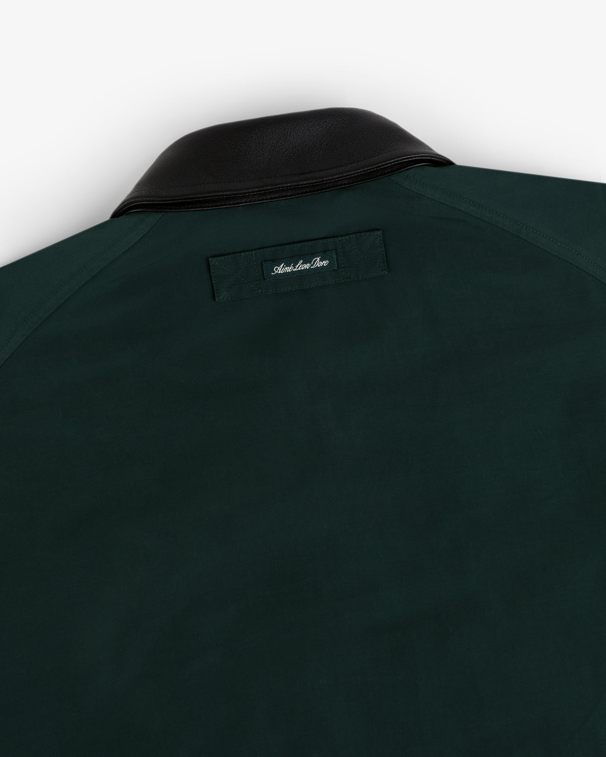 Lightweight Barn Jacket in dark green with black leather collar, rear view showing a small label below the collar.