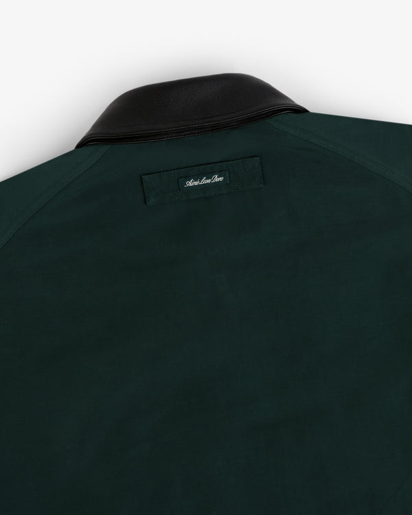 Lightweight Barn Jacket in dark green with black leather collar, rear view showing a small label below the collar.