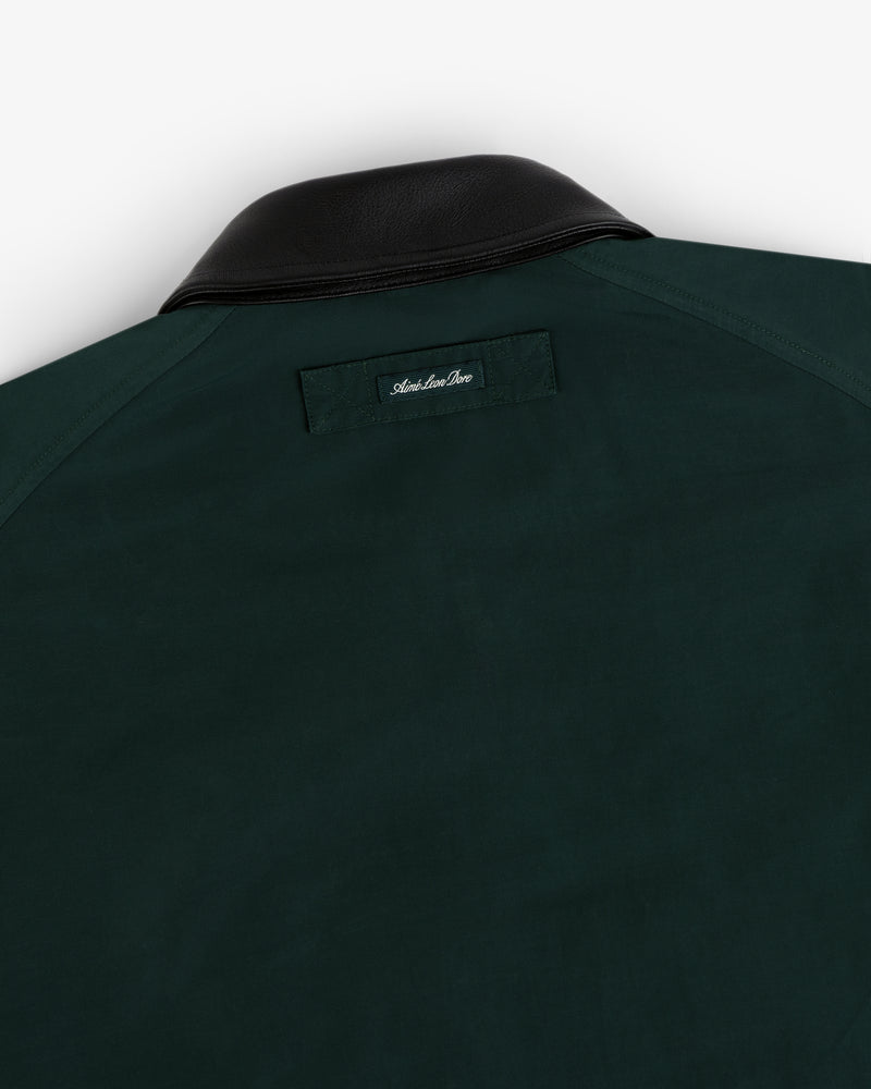 Lightweight Barn Jacket in dark green with black leather collar, rear view showing a small label below the collar.