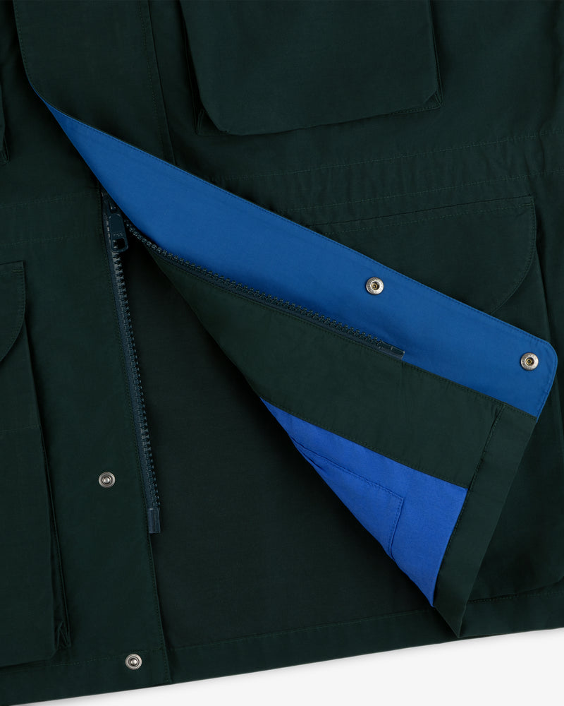 Close-up of the Lightweight Barn Jacket in dark green with blue lining, featuring zipper, snap buttons, and pockets.