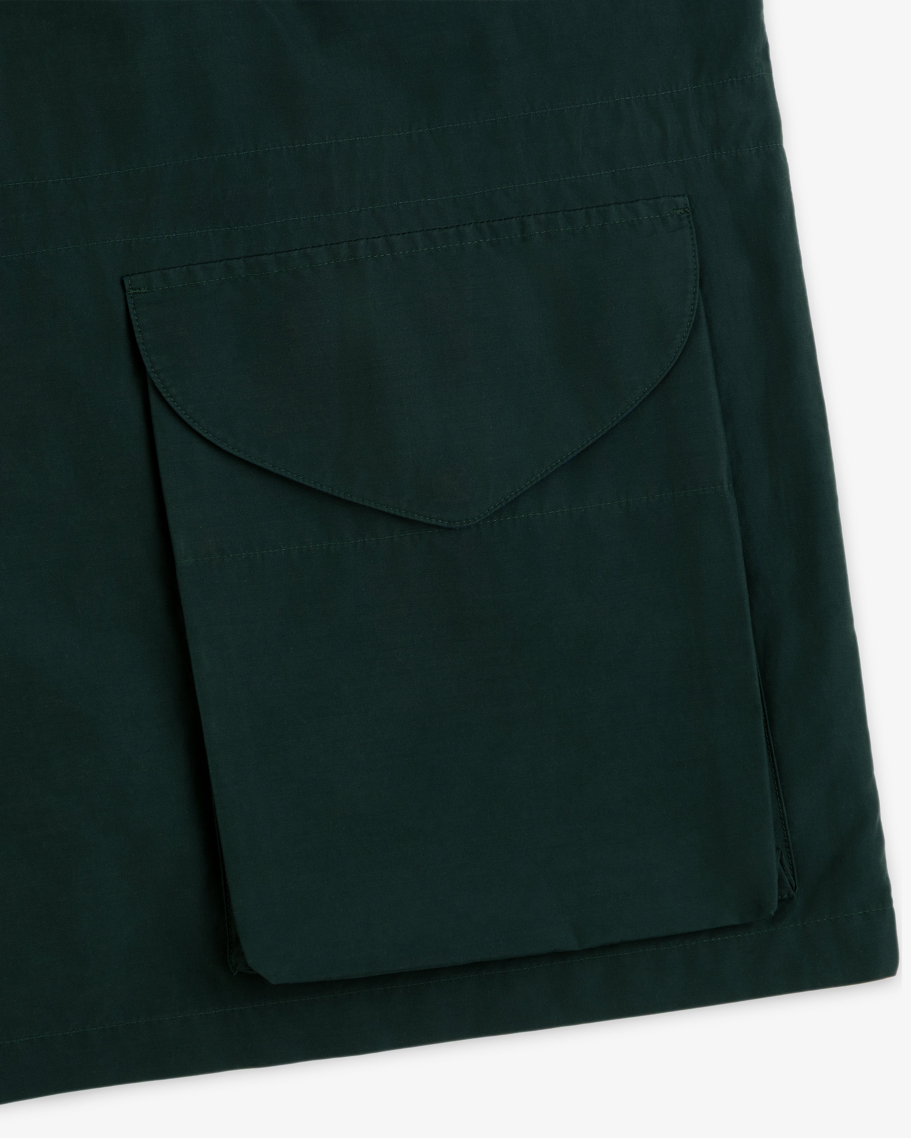 Close-up of dark green Lightweight Barn Jacket featuring a large sewn-on flap pocket.