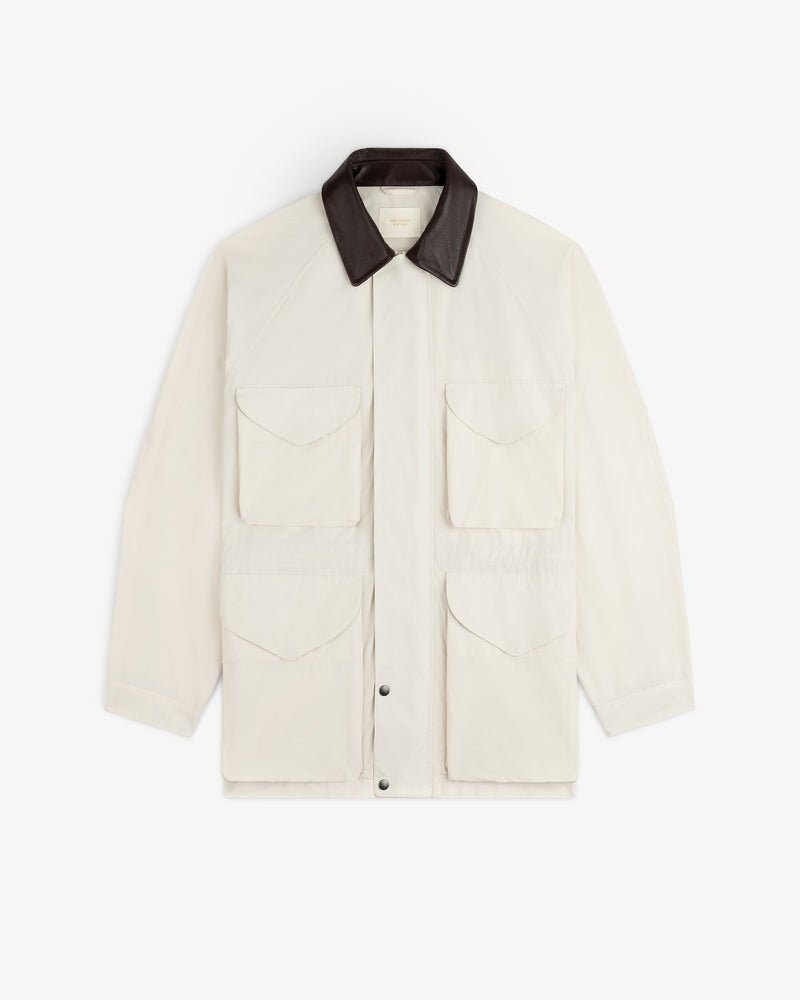 Lightweight Barn Jacket in cream with four front flap pockets, black collar, shown laid flat on white background.