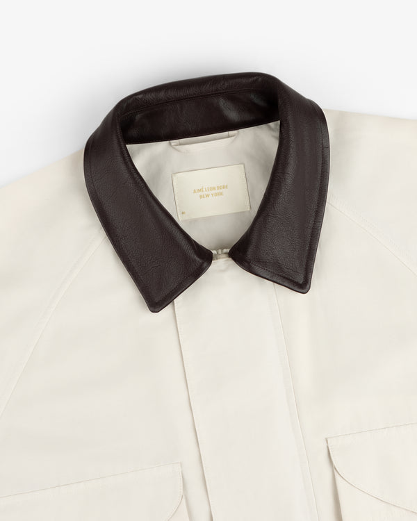 Lightweight Barn Jacket in cream with a dark brown leather collar and visible beige brand label inside.