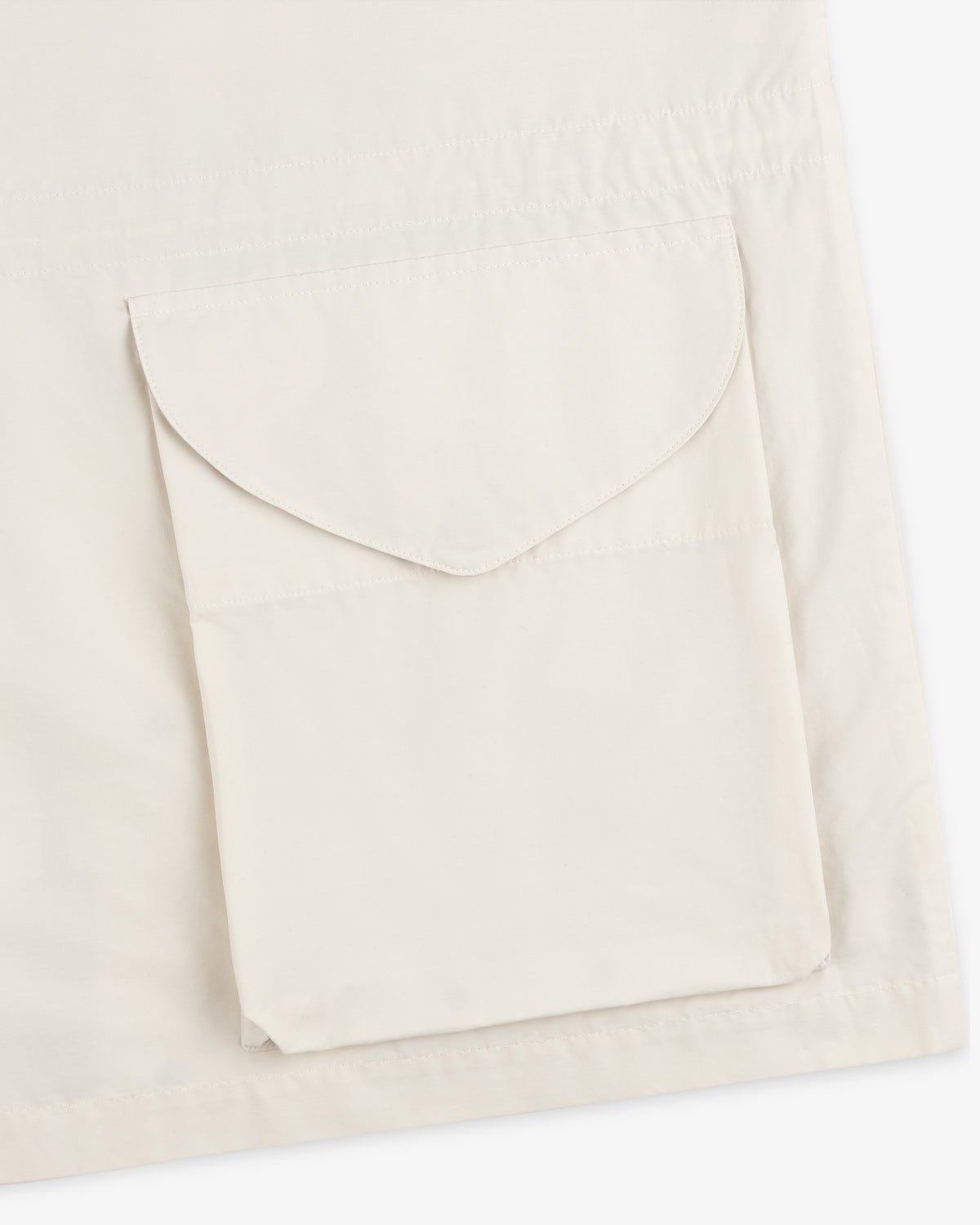 Close-up of a beige Lightweight Barn Jacket with a flap pocket on the front.
